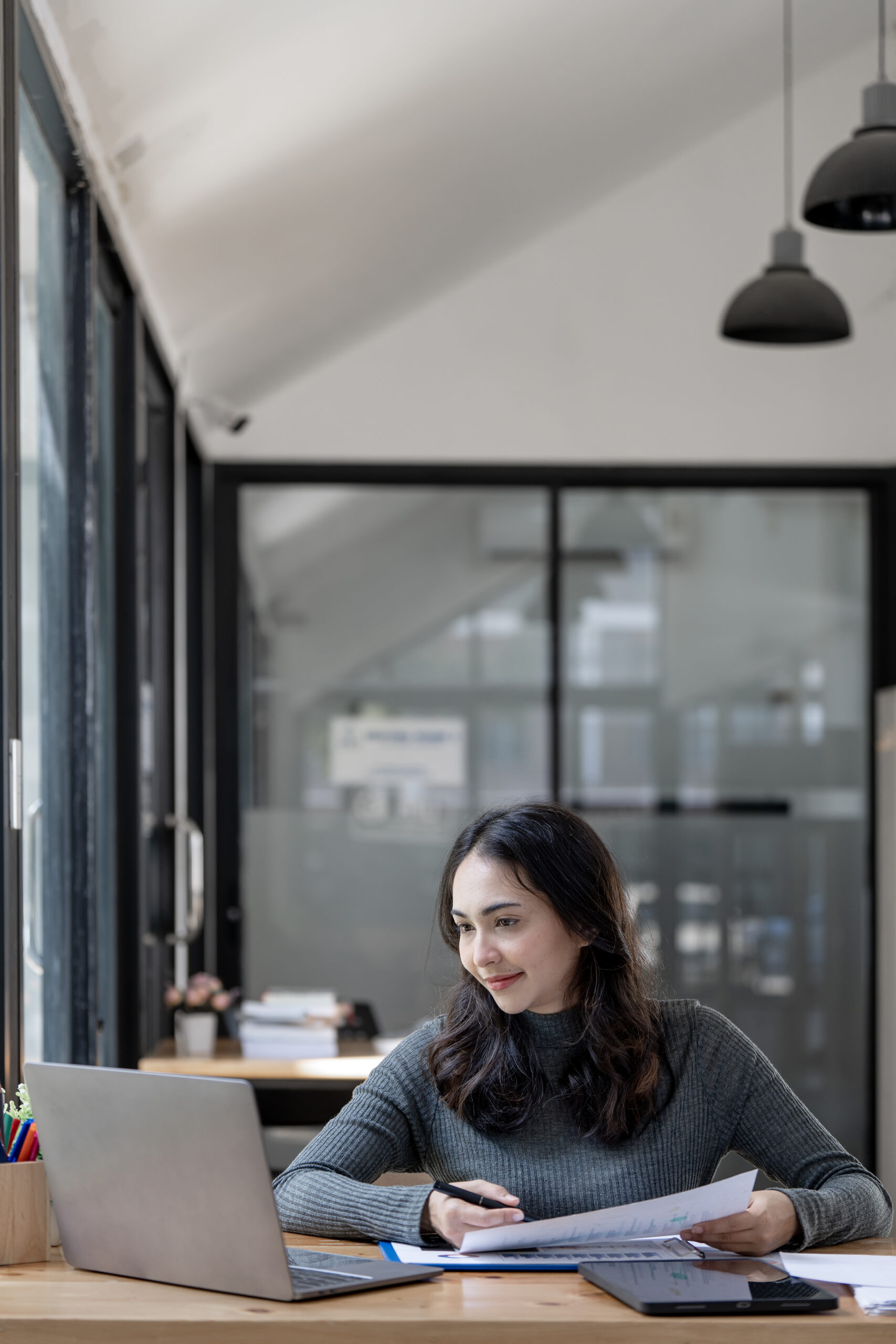 Portrait of beautiful asian indian woman working on document and
